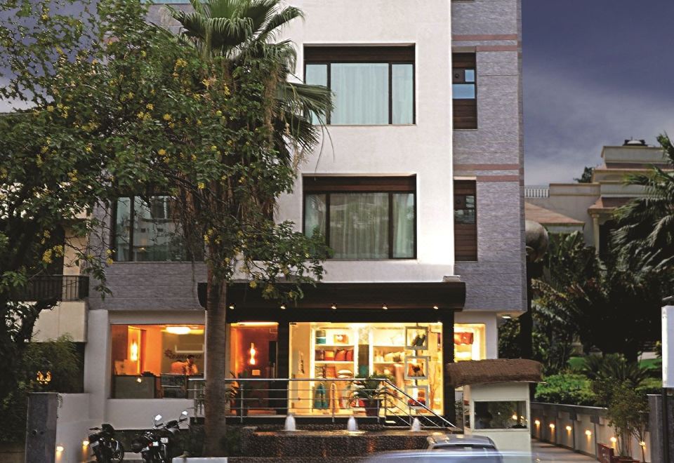 "a modern building with multiple floors , balconies , and a sign that says "" chamber of commerce "" in the window" at Amara Hotel