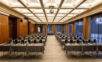 a large conference room with rows of tables and chairs arranged for a meeting or event at Everness Hotel & Resort