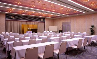 a large conference room filled with rows of chairs and tables set up for an event at Todaya