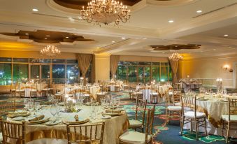 a large , elegant dining room with multiple tables and chairs set up for a formal event at St. Kitts Marriott Resort & the Royal Beach Casino