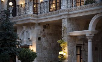 a stone building with an open courtyard , where several couches and chairs are arranged for relaxation at Sacred House