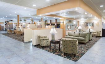 a hotel lobby with several chairs and couches , creating a comfortable and inviting atmosphere for guests at Holiday Inn Riverton-Convention Center