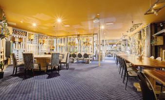 a large dining room with multiple tables and chairs , as well as a bar area at Archibald Hotel