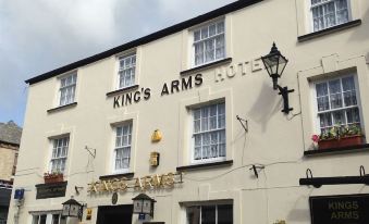 "a white building with the words "" king 's arms hotel "" prominently displayed on the side of the building" at King's Arms