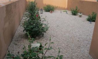 a row of small , wooden cabins situated on a grassy field , with trees in the background at Hostal Sol de la Vega