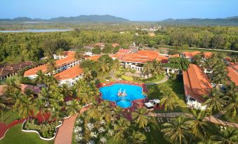 aerial view of a resort with a large pool surrounded by palm trees and buildings at Holiday Inn Resort Goa