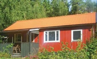 a modern bedroom with wooden floors , white beddings , and a large window , featuring a blue chair , yellow towels , and a flat - at Holiday Home Frändefors Binäs