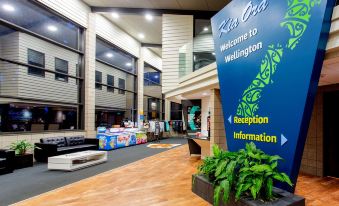 a lobby area of a hotel , featuring a reception desk and a large sign welcoming guests at Wellington Top 10 Holiday Park