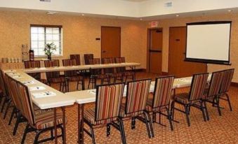 a conference room set up for a meeting , with chairs arranged in rows and a projector on the wall at Comfort Inn & Suites Chillicothe