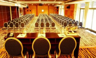 a large conference room with rows of chairs arranged in a semicircle , ready for an event at Radisson Blu Hotel, Bamako