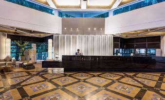 a modern hotel lobby with a reception desk and a large screen on the wall at DoubleTree Resort by Hilton Hotel Penang