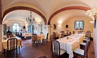 a large dining room with multiple tables and chairs arranged for a group of people to enjoy a meal together at Palazzo Leopoldo Dimora Storica & Spa