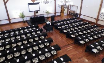 a large conference room with wooden floors and rows of tables set up for a meeting at The Lodges at Gettysburg