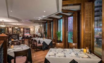 A restaurant is prepared for a business luncheon with tables and chairs arranged in the center at Novotel Century Hong Kong