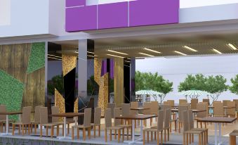 a modern restaurant with wooden chairs and tables , a purple awning , and a large advertisement on the side at Favehotel Cimanuk Garut