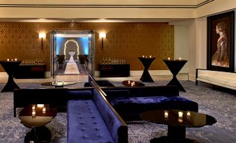 a luxurious hotel lobby with various seating options , including couches and chairs , as well as candles at The Fontaine