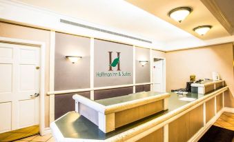 "a modern office interior with a reception desk , large windows , and the name "" h "" on the wall" at Country Inn & Suites by Radisson, Hoffman Estates, IL