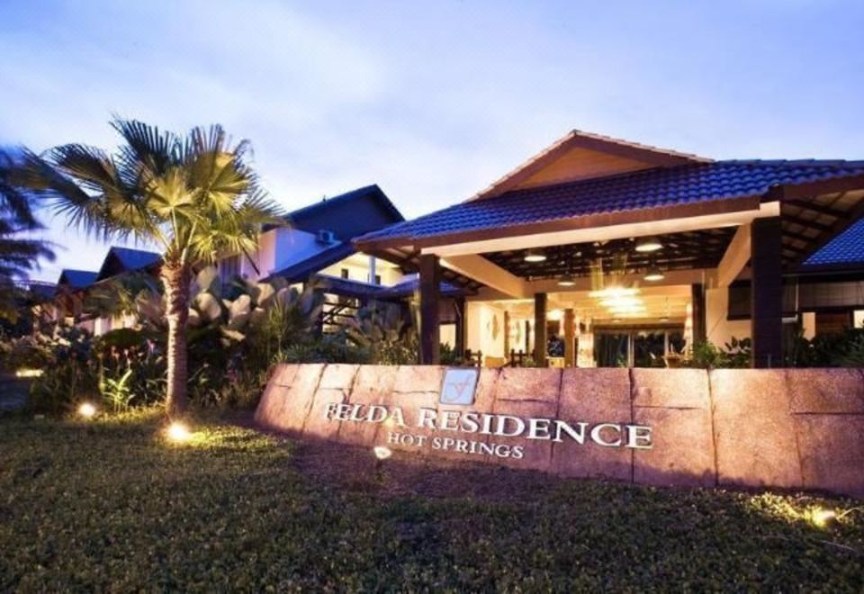 "a large house with a sign that reads "" hilton residence "" in front of it" at Felda Residence Hot Springs