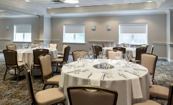 a large dining room with multiple round tables and chairs , all set up for a formal event at Delta Hotels Basking Ridge