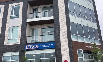 "a brick building with a blue sign that reads "" ica "" and another sign on the ground floor" at My Place
