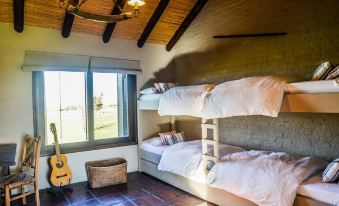 a room with three bunk beds , two of which are stacked on top of each other at Santa Virginia