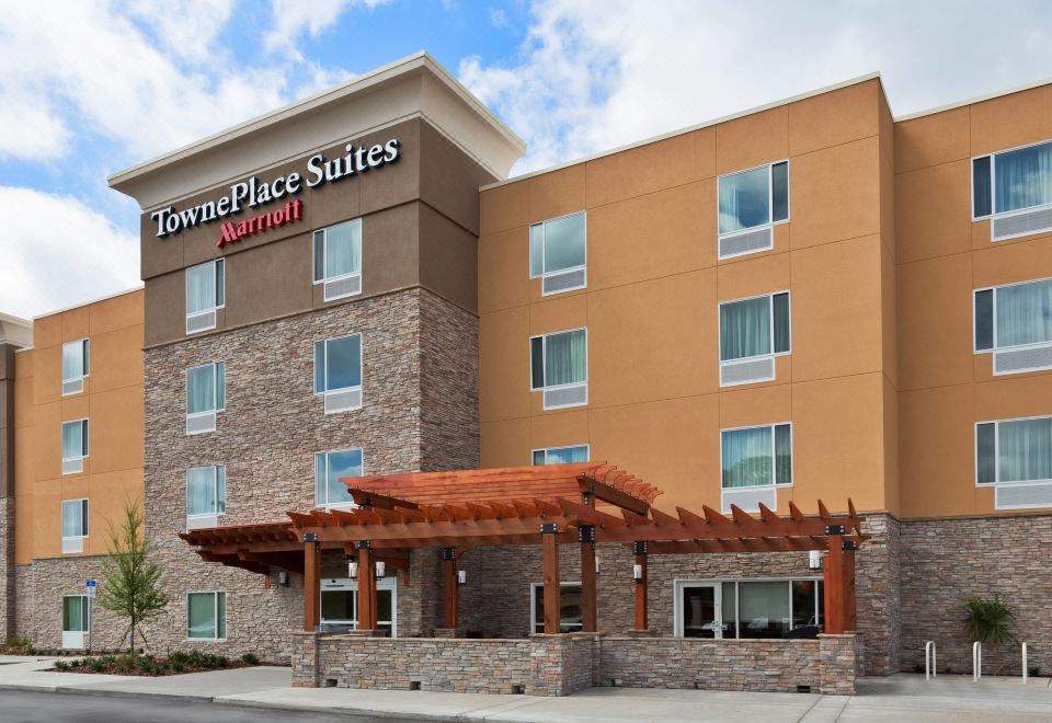 "a large hotel with a sign that says "" town place suites "" on the side of the building" at TownePlace Suites Gainesville Northwest