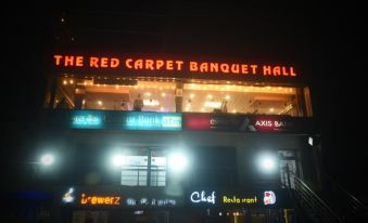 "a nighttime scene of a building with a large neon sign that reads "" red carpet banquet hall .""." at Red Carpet