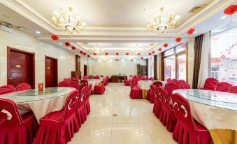 A room in the hotel's main dining hall is set up with tables and chairs for an event at Famen Temple Hotel