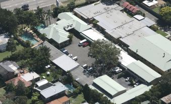 a bird 's eye view of a parking lot with cars and buildings in the background at Abcot Inn