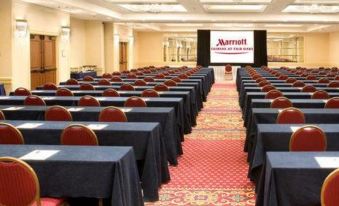 a large conference room filled with rows of chairs and tables , ready for a meeting or event at Courtyard by Marriott Fairfax Fair Oaks