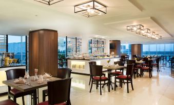 a large dining room with multiple tables and chairs arranged for a group of people to enjoy a meal together at Best Western Premier la Grande Hotel