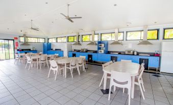a large , open dining room with several tables and chairs arranged for a group of people to enjoy a meal at Discovery Parks - Ballina
