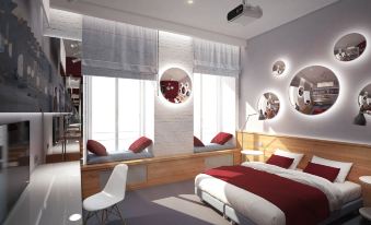 a modern bedroom with a large bed , white walls , and red accents , as well as multiple mirrors on the walls at Fabrika
