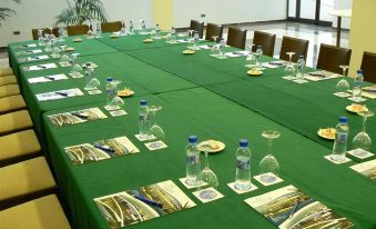 a long conference table set up for a meeting , with several bottles of water placed on it at Hotel Flamingo