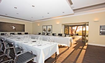 a long dining table set up for a formal event , with several chairs arranged around it at The Louise