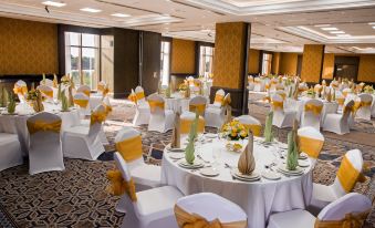 a large banquet hall with tables and chairs set up for a formal event , possibly a wedding reception at Ayla Grand Hotel Al Ain