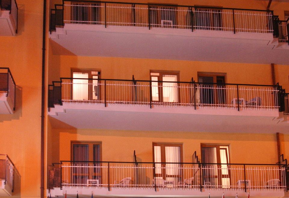 a hotel with a large sign above the entrance and multiple balconies on the side at Florida
