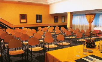 a conference room with rows of chairs arranged in a semicircle , ready for a meeting at Hotel Riu Palace Oasis