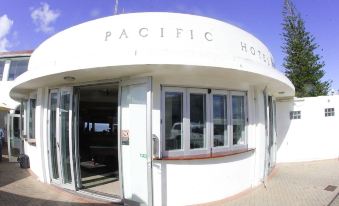 "a white building with the word "" pacific hotel "" written on it , located near a body of water" at Pacific Hotel Yamba