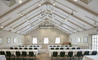 a large room with high ceilings and rows of tables and chairs , possibly a conference or meeting space at Pine Mountain State Resort Park