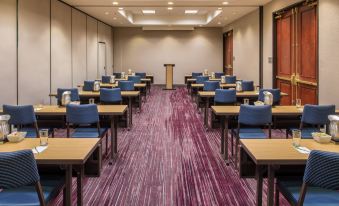 a large conference room with rows of chairs arranged in a semicircle , providing seating for a group of people at Courtyard Seattle Federal Way
