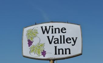 "a sign for the "" wine valley inn "" with grapes and the words "" wine valley inn "" written on it" at Wine Valley Inn