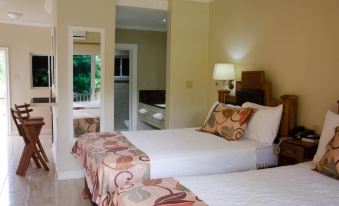 a hotel room with two beds , one on the left and one on the right side of the room at Oasis Resort