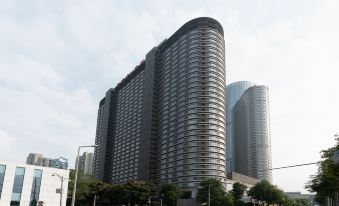 A large building with an office tower in the center and additional buildings on both sides at Rayfont Hotel & Apartment Chengdu