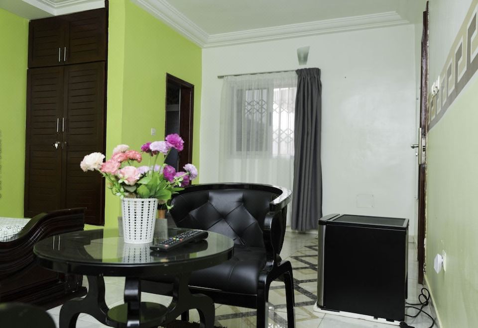 a dining room with a black dining table and chairs , along with a potted plant on the table at Dream Hotel