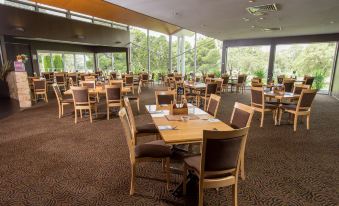 a large dining room with multiple tables and chairs , creating an inviting atmosphere for guests at Renmark Country Club
