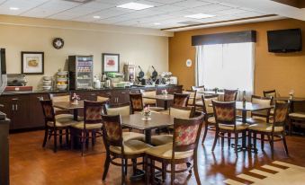 a dining room with tables and chairs arranged for a group of people to enjoy a meal together at Comfort Suites
