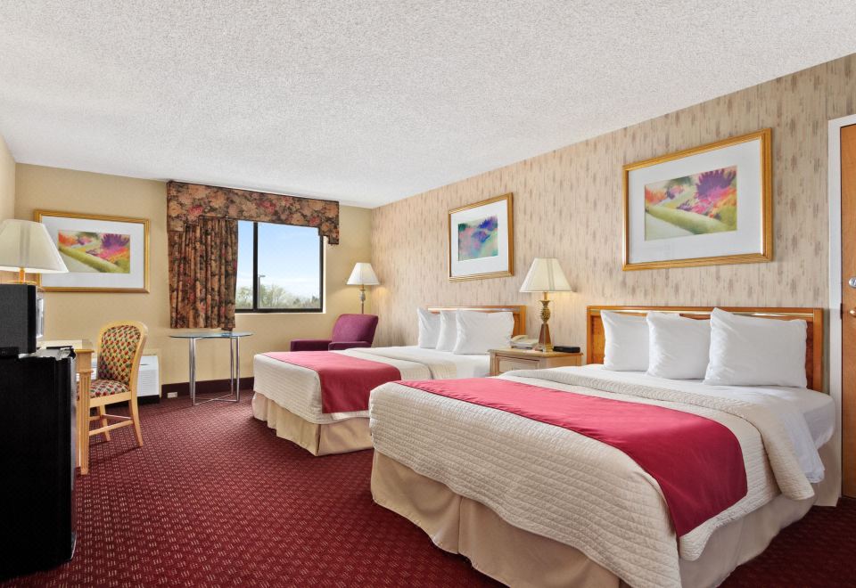 a hotel room with two beds , one on the left and one on the right side of the room at Oh St Joseph Resort Hotel