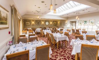 a large dining room with multiple tables and chairs , some of which are set for a meal at Cbh Park Farm Hotel