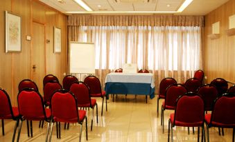 a conference room set up for a meeting , with chairs arranged in rows and a whiteboard on the wall at Hotel Los Angeles